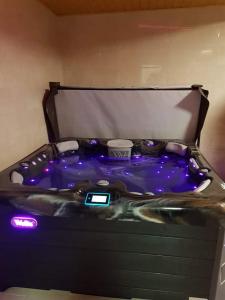 a jacuzzi tub with lights on top of it at Cserh&aacute;tv&ouml;lgy Panzi&oacute; in Als&oacute;told