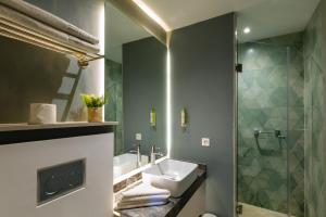 a bathroom with a sink and a shower at AppartHotel Atrani in Marrakesh +41 photos