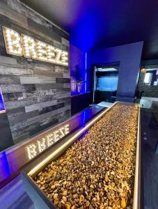 a rock pool in a hotel room with a stone wall at BREEZE SUITES - LUXURY GROUP ACCOM - SLEEPS 19 in Blackpool