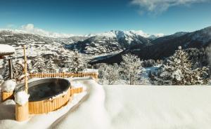 een hot tub op de top van een met sneeuw bedekte berg bij Golmerhaus in Schruns