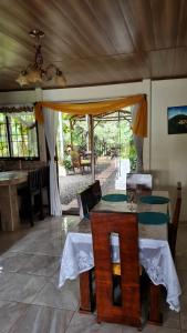 a dining room with a table and chairs and a patio at Casa Arboleda-Full House by the River and Forest and Gardens in San Francisco