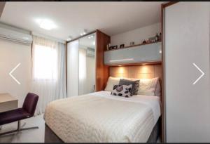 a bedroom with a bed and a desk and a chair at LIFE RESORT in Brasilia