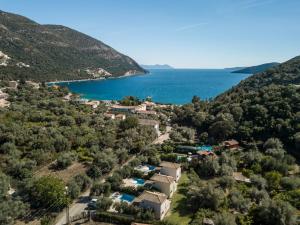 an aerial view of a villa with a lake at Rodi-Poros Green Village in Mikros Gialos