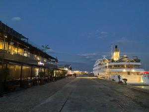 a large cruise ship is docked at a dock at МareliS Luxe Port Apartment in Varna City
