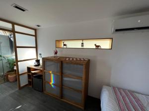 a bedroom with a bed and a mirror on the wall at H20 Container Cabins in San Agustinillo