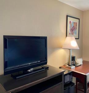 a large flat screen tv sitting on top of a table at Red Bluff Inn in Red Bluff