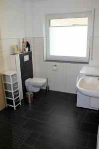 a bathroom with a toilet and a sink at Backbord in Horumersiel