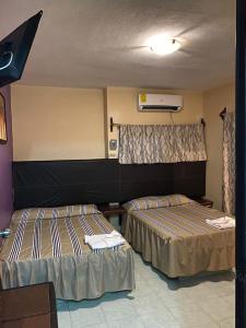 a hotel room with two beds in a room at Hotel Frailes in Arriaga