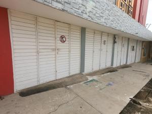 a row of white garage doors on a building at Hotel Frailes in Arriaga +13 photos