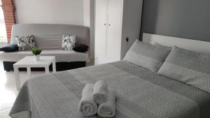 a bedroom with a bed with towels on it at Estudio TORROX PLAYA- vistas al mar y piscina in Torrox Costa