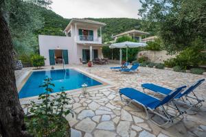 a villa with a swimming pool and a house at Rodi-Poros Green Village in Mikros Gialos
