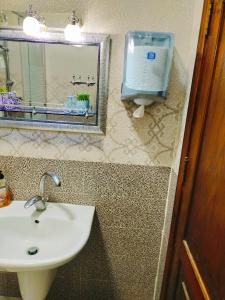 a bathroom with a sink and a mirror at Maria Home in Madaba