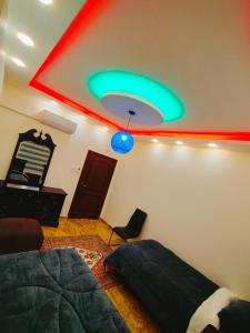 a bedroom with a green and red ceiling at Maria Home in Madaba