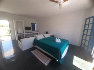 a bedroom with a bed in a room with a ceiling fan at Pousada Tabuleiro in Carmo do Rio Claro