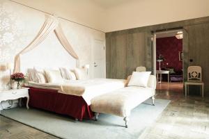 a bedroom with a large bed and a window at Bjertorp Slott in Kvänum