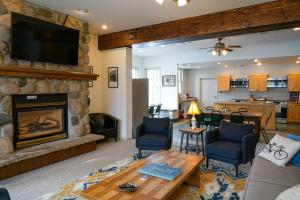 a living room with a fireplace and a tv at Crested Butte Hostel in Crested Butte