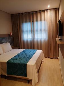 a bedroom with a large bed and a window at Ilhéus North Residence Danilo in Uruçuca +18 photos