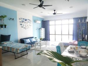 a living room with blue walls and a table at Palazio AegeanSea Homestay By Easyhomestay in Johor Bahru