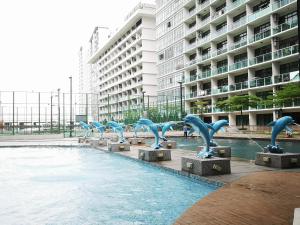 a group of dolphin statues in front of a pool of water at Palazio AegeanSea Homestay By Easyhomestay in Johor Bahru