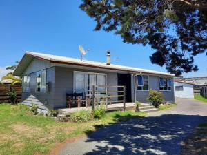 a house with a windmill on top of it at Mount Budget Accommodation in Tauranga