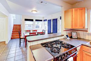 a kitchen with a stove top oven next to a table at Beautiful South in Austin