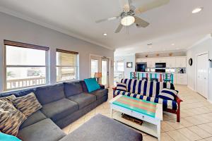a living room with a couch and a ceiling fan at Gulf Breezes & Dune Dreams in Port Aransas