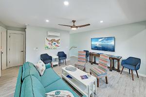 a living room with a blue couch and chairs at Dolphins Heart & Palms Starfish in Rockport