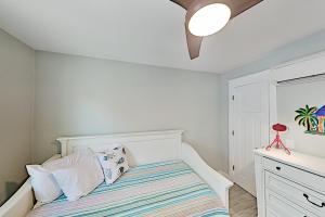 a white bedroom with a bed and a dresser at Dolphins Heart & Palms Starfish in Rockport