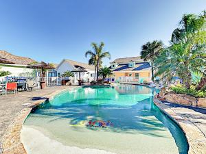 a swimming pool with a toy in the water at Sail Away at Pirate's Bay Unit 113 in Port Aransas