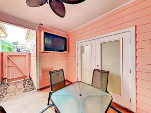 a dining room with a glass table and chairs at Sail Away at Pirate's Bay Unit 113 in Port Aransas