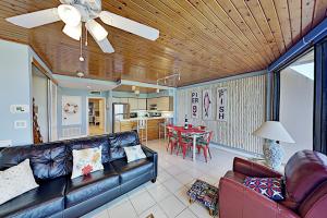 a living room with a couch and a table at Mayan Princess Beach Condos in Padre Island