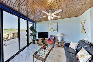 a living room with a couch and a ceiling fan at Mayan Princess Beach Condos in Padre Island