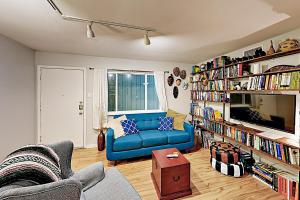a living room with a blue couch and book shelves at Creekside Terrace Condominiums #211 in Austin