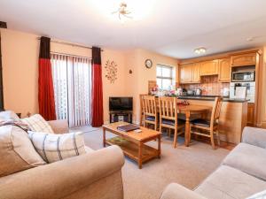 a living room with a couch and a table at The Ramblers' Annex in North Tuddenham