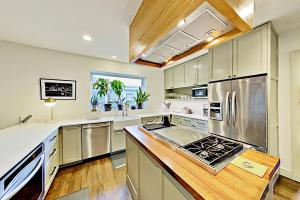 a kitchen with stainless steel appliances and wooden floors at Love Escape in Austin