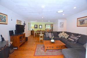 a living room with a couch and a coffee table at Teach Na Cairde - House of Friends in Blackheath