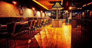 a bar with chairs and tables and a brick wall at Eriza Hotel in Erzincan