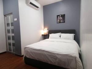 a bedroom with a large bed with white sheets at Hi TechSTAY in Lunas