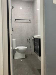a bathroom with a toilet and a sink at Hi TechSTAY in Lunas
