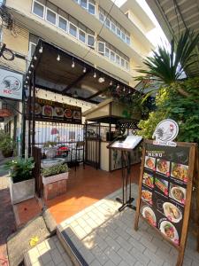 a restaurant with a sign in front of a building at KC guest house in Bangkok