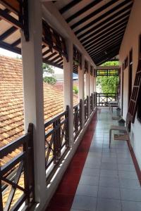 a corridor of a building with a view of a field at KoolKost At Tenggilis - Minimum Stay 30 Nights in Tenggilismedjojo
