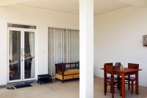 two views of a room with a table and chairs at Ella Touch in Ella