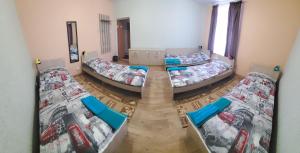 a room with four beds in a room at Хостел"Компас" in Kungur