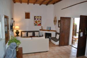 a living room with a couch and a fireplace at Casa Can Coves in Santa Gertrudis de Fruitera