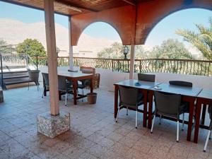 two tables and chairs on a patio with a view of the desert at Amenophis Hotel in Luxor