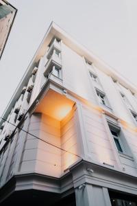 a tall white building with an open window at BUSINESS LIFE HOTEL BAKIRKÖY in Istanbul