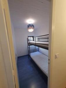 a hallway with two bunk beds in a room at La maison du lac in Doussard
