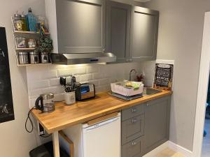 a kitchen with a counter top with a sink at Dove House in Congleton