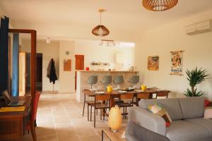 ein Wohnzimmer mit Sofa und Tisch in der Unterkunft Maison Le Grand Verger in Goult