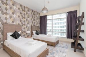 A bed or beds in a room at Vacay Lettings - Loft Downtown Dubai